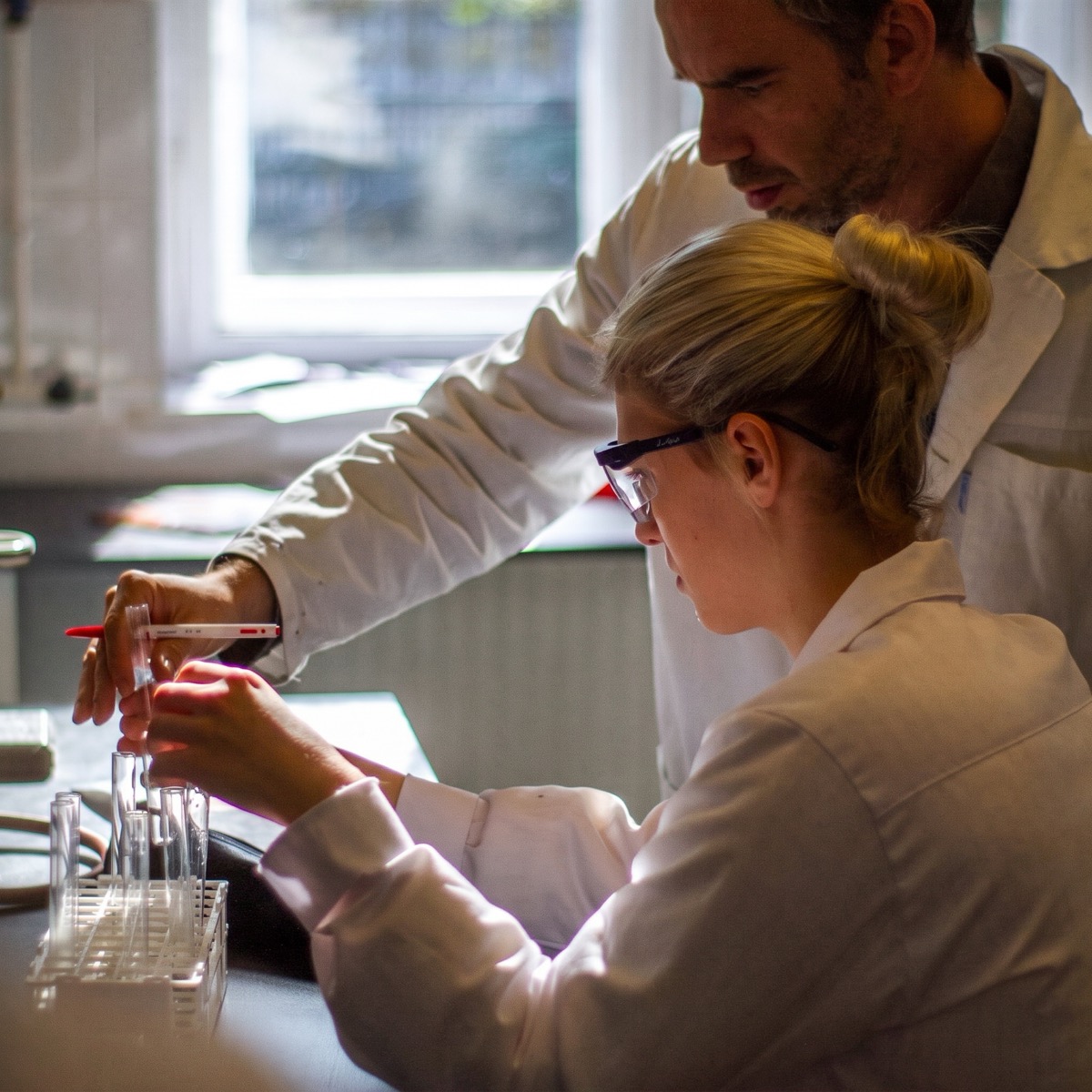 Two researchers working together at the lab bench